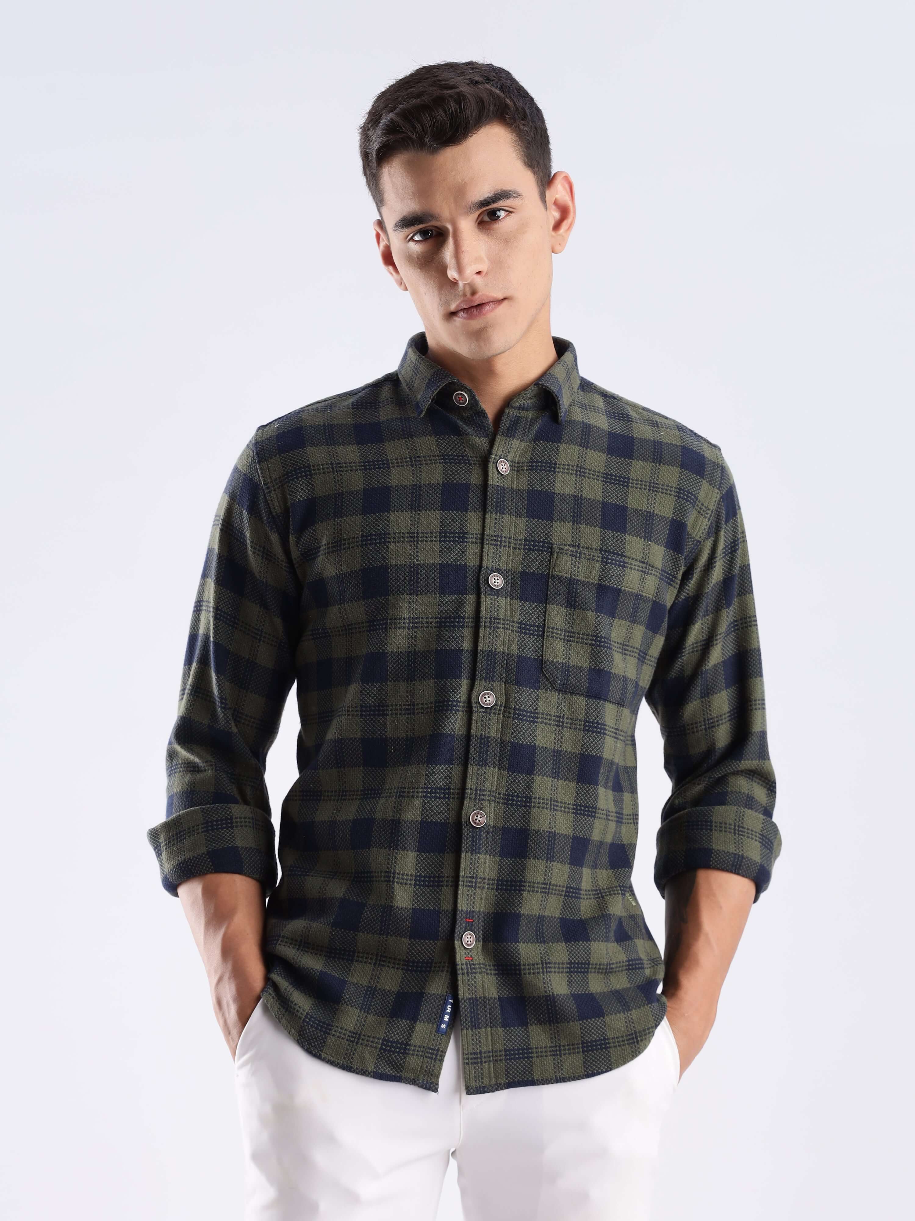 Man wearing a sustainable recycled cotton shirt in a green check pattern, showcasing style and functionality.