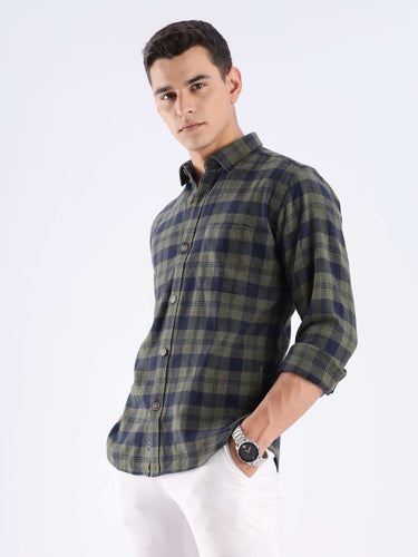 Man modeling a sustainable recycled cotton checked shirt by Turms, showcasing its stylish design and durability.