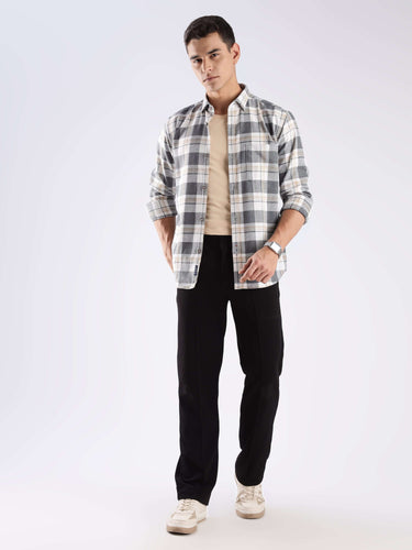 Model wearing Urban Ochre Turms recycled cotton checked shirt, showcasing sustainable style and cool tech features.