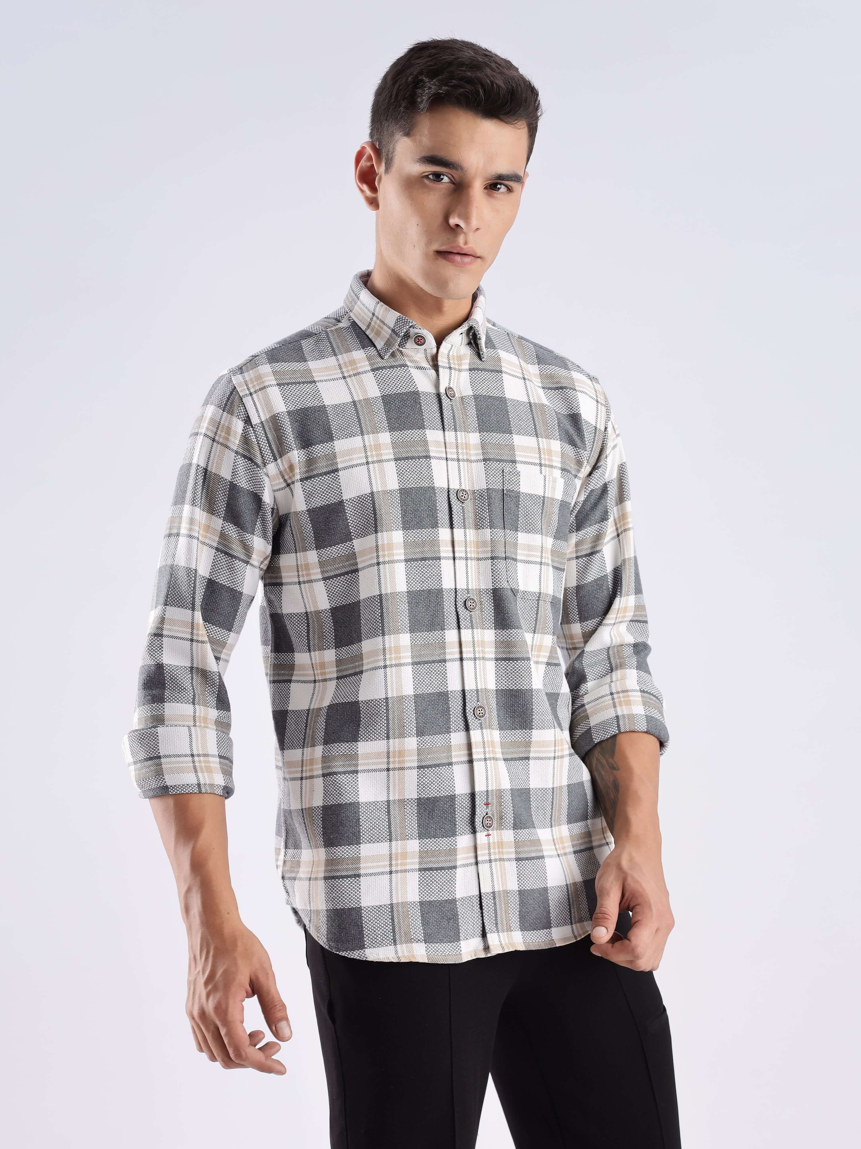 Stylish male model wearing Turms recycled cotton checked shirt in urban ochre design, combining fashion and sustainability.