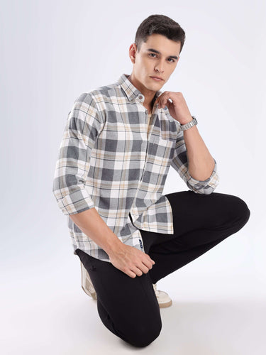 Man modeling the Urban Ochre Turms recycled cotton checked shirt, showcasing its stylish design and comfortable fit.