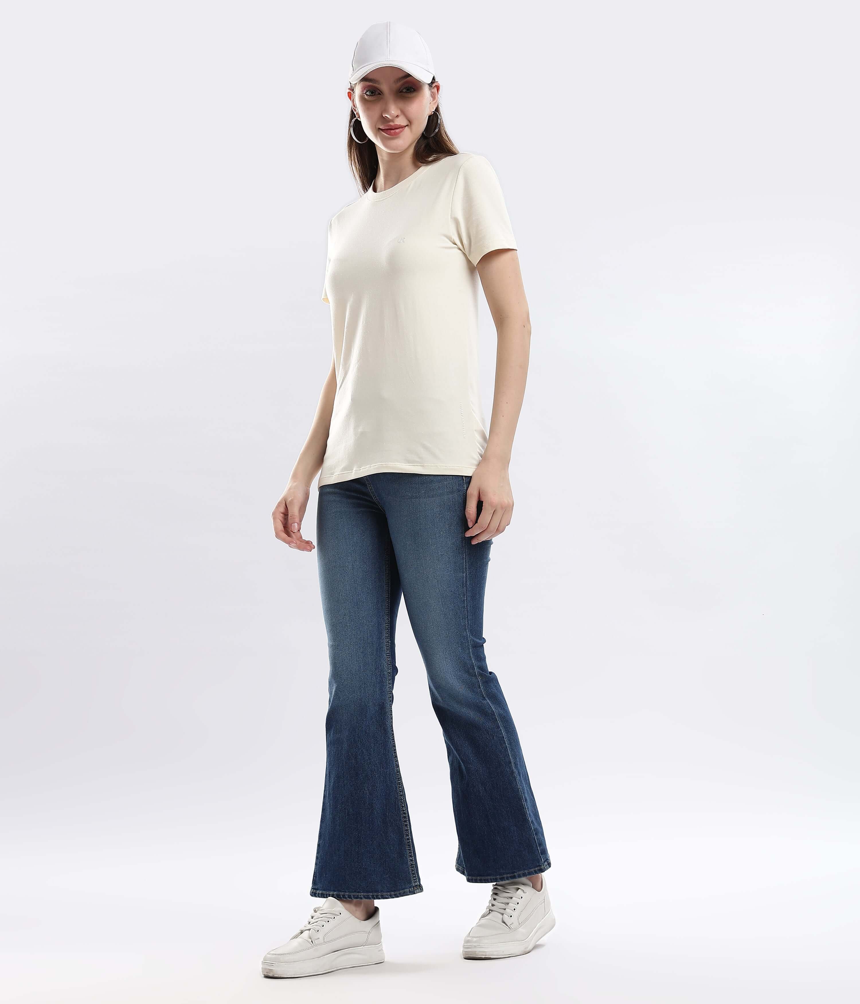 Model wearing Polar Off-white cotton t-shirt with denim jeans and a cap, showcasing style and comfort.