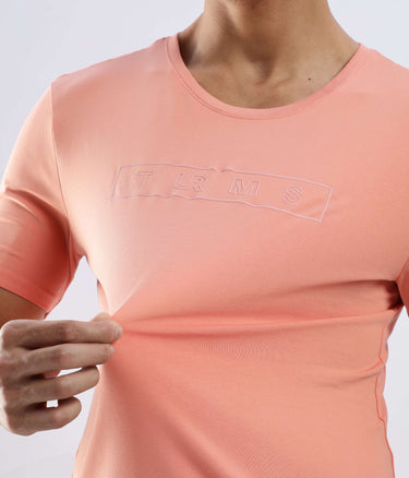 Model showcasing the Ember Orange Turms Worry-Free Intelligent T-Shirt, made from stretchable cotton with anti-odour features.
