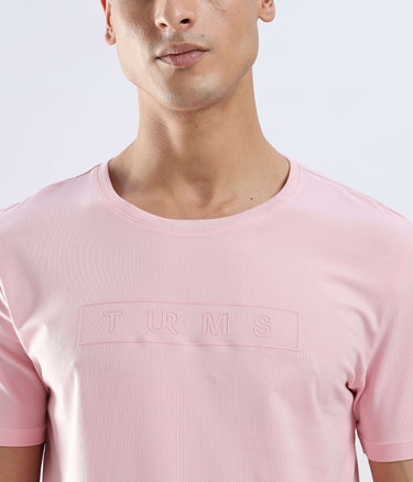 Model wearing a Quartz Pink Turms Worry-Free Intelligent T-Shirt, showcasing its sleek design and superior cotton fabric.