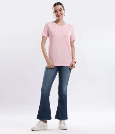 Model wearing Womens casual t-shirt Quartz Pink cotton t-shirt with flared jeans, showcasing style and comfort.