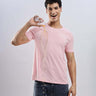 Man wearing Quartz Pink cotton tshirt demonstrating its waterproof features, showcasing style and functionality.