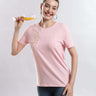 Model wearing Womens casual t-shirt Quartz Pink T-shirt, enjoying a drink, showcasing style, comfort, and durability of the best t-shirt.