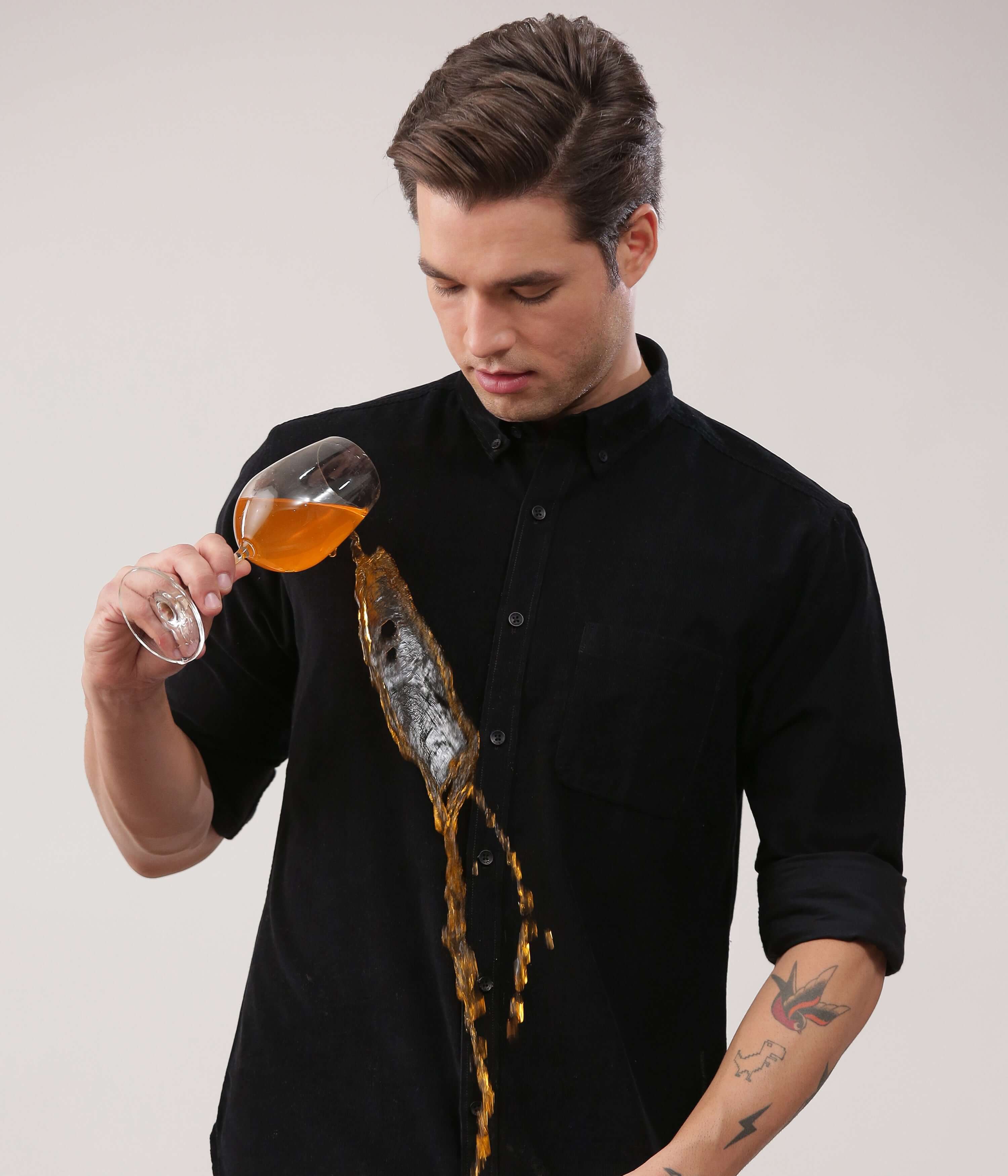 Black Beauty corduroy shirt demonstrating waterproof features with spilled drink, showcasing Turms Intelligent Apparel.