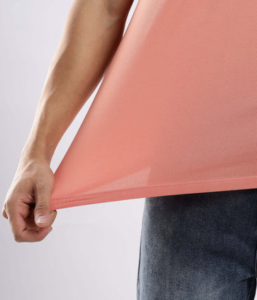 Close-up of a man showcasing the stretchable Ember Orange cotton tshirt, highlighting its premium quality and fit.