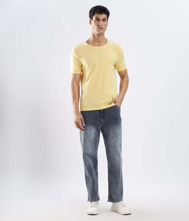 Man wearing the Aura Yellow cotton t-shirt, showcasing its stretchable, waterproof, and anti-odour features.