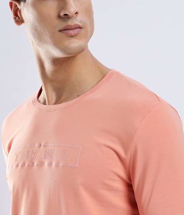Model wearing the Ember Orange Turms Worry-Free Intelligent T-Shirt, showcasing its stylish design and comfort.