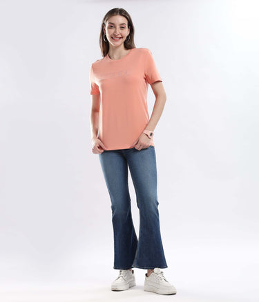 Model wearing Womens casual t-shirt Ember Orange Turms Worry-Free Intelligent T-Shirt with jeans, showcasing style and comfort.