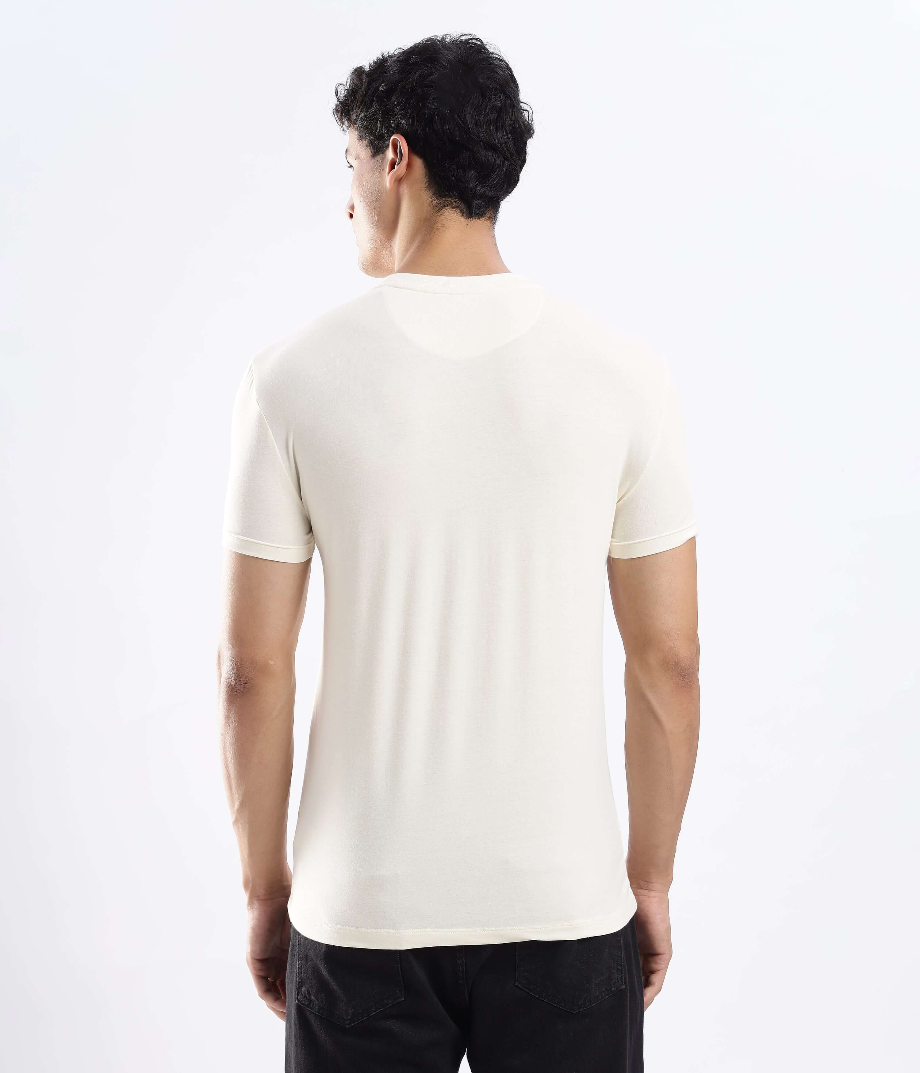 Back view of a man wearing a Polar Off-white cotton t-shirt, showcasing its stretchable and waterproof features.