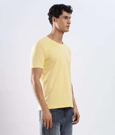 Aura Yellow cotton tshirt on a model, showcasing its stretchable, waterproof, and anti-odour features.