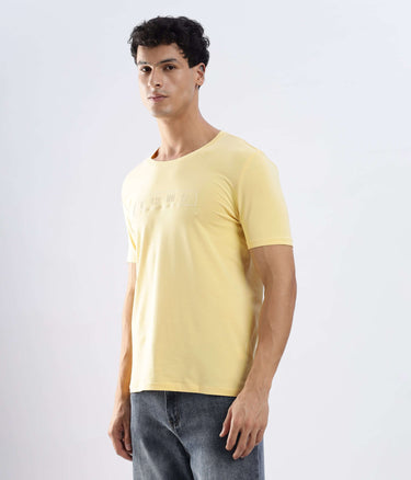 Model wearing Aura Yellow cotton tshirt, stretchable, waterproof, and anti-odour, perfect for casual everyday wear.