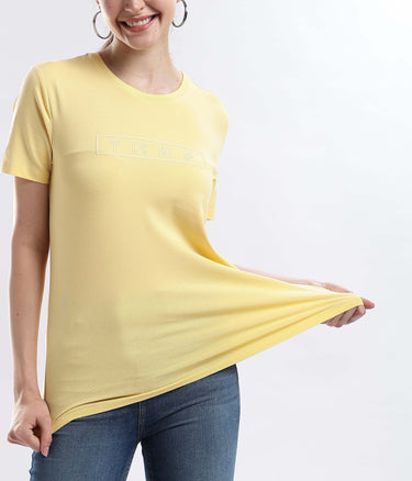Model showcasing Womens casual t-shirt Aura Yellow cotton tshirt, highlighting its stretchable, waterproof, and anti-odour features.