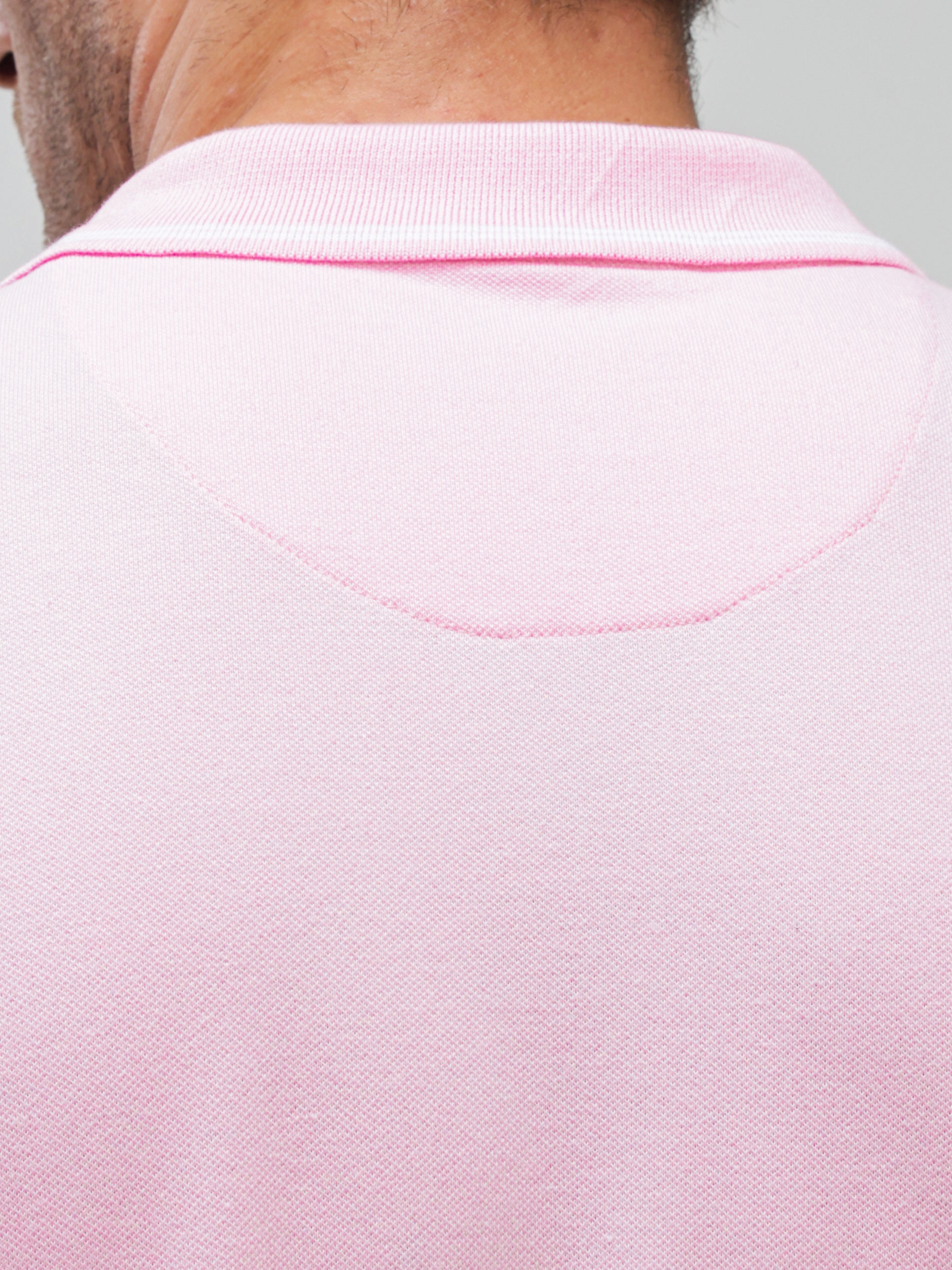Close-up of the back of a Carnation Turms Polo T-shirt featuring tailored fit and premium cotton fabric with anti-stain and anti-odor properties.
