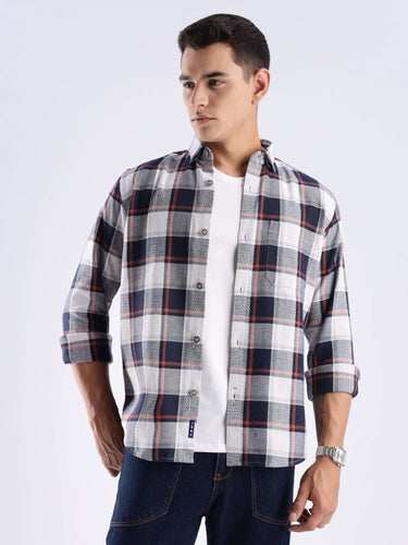 Model wearing a sustainable blue matrix checked shirt made of recycled cotton, showcasing style and functionality.