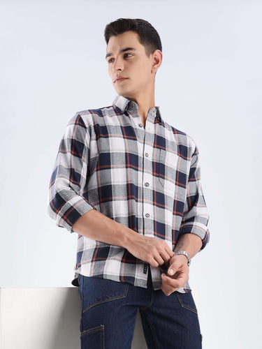 Stylish man wearing a sustainable recycled cotton checked shirt from Turms, showcasing cool tech features and durability.