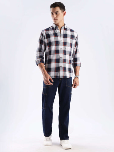 Man wearing a blue matrix recycled cotton checked shirt with stylish cargo pants, showcasing sustainable fashion.