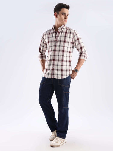 Stylish man wearing a recycled cotton checked shirt and cargo pants, showcasing sustainable fashion and cool tech innovation.