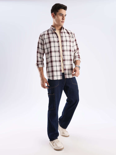 Man wearing a sustainable Turms recycled cotton checked shirt and jeans, showcasing style and functionality.