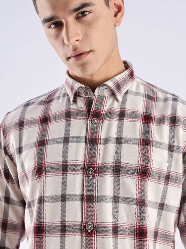 Man wearing a sustainable recycled cotton checked shirt, showcasing its stylish design and durability.