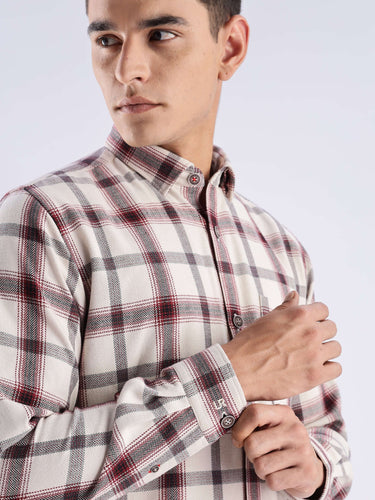 Man wearing a stylish plaid recycled cotton shirt by Turms, showcasing functionality and sustainable fashion.