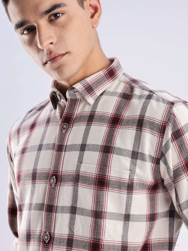 Man wearing a sustainable recycled cotton checked shirt featuring a stylish plaid design and high-quality craftsmanship.