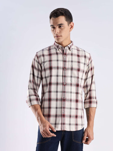 Stylish man wearing a rustic plaid recycled cotton shirt, showcasing sustainable fashion with a cool tech feature.