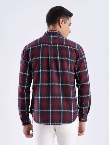Back view of a man wearing a checkered recycled cotton shirt in red and navy for sustainable fashion.