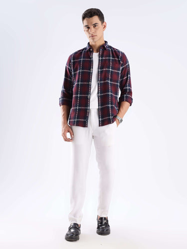 Man wearing a checkered maze shirt made of recycled cotton, showcasing a stylish and sustainable look.