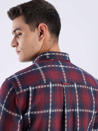 Man wearing a checkered recycled cotton shirt, showcasing its stylish back design and quality craftsmanship.