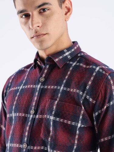 Man wearing Turms Intelligent Recycled Cotton Checked Shirt, showcasing style and sustainability in bold checkered design.