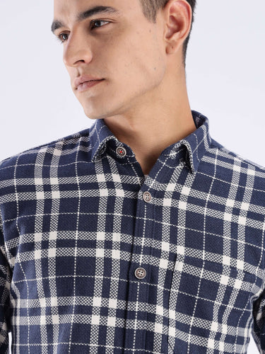 Model wearing a sustainable checked shirt made of recycled cotton, highlighting style and cool tech features.