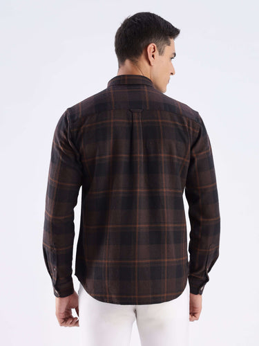 Back view of a man wearing a Rustic Nightshade recycled cotton checked shirt, showcasing its stylish design and durable weave.