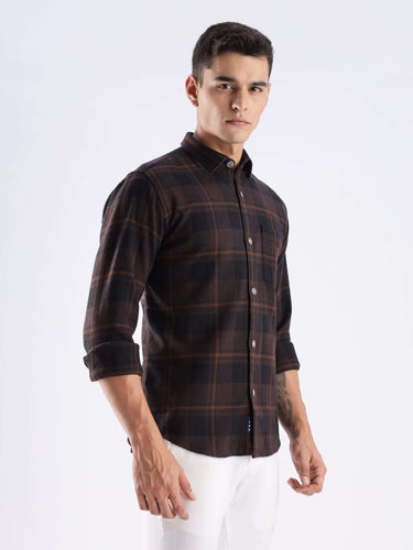 Model wearing a rustic nightshade checked shirt made from recycled cotton, showcasing style and durability.