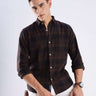 Model wearing a rustic nightshade recycled cotton checked shirt, showcasing style and sustainable fashion.