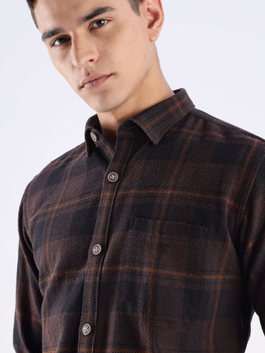 Man wearing a rustic recycled cotton checked shirt with button details, showcasing sustainable fashion and style.