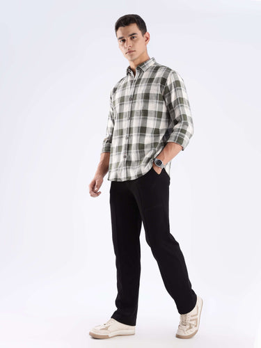 Man wearing Mint Falls Turms recycled cotton checked shirt with black pants and sneakers, showcasing sustainable fashion.