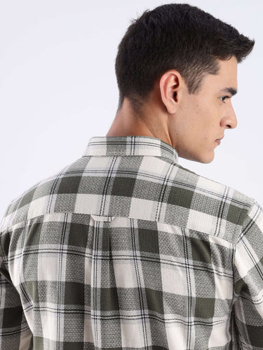 Back view of a man wearing a mint green checked recycled cotton shirt showcasing its stylish design.