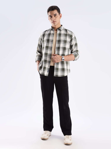 Man in a checked recycled cotton shirt, showcasing sustainable style with anti-odour and water-repellent features.