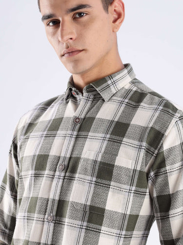 Model wearing a sustainable recycled cotton checked shirt in green, showcasing style and durability for everyday luxury.