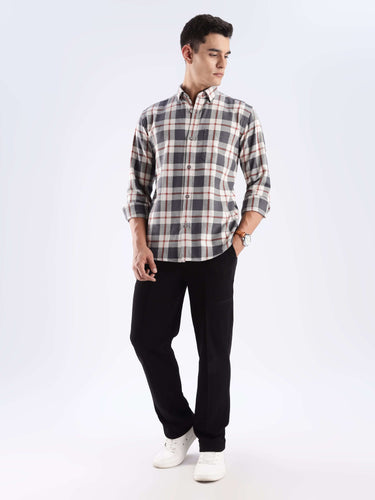 Man wearing a grey plaid recycled cotton shirt, showcasing sustainable fashion and stylish everyday wear.