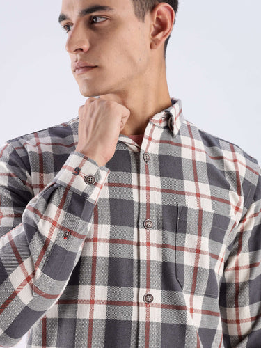 Man wearing a grey checked shirt made from recycled cotton, featuring stylish design and long-lasting quality.