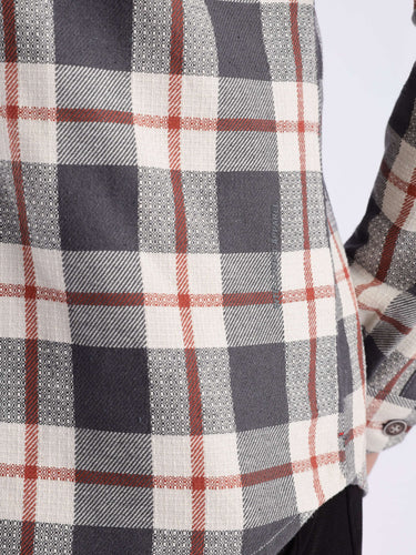 Close-up of a grey checked shirt showcasing the recycled cotton fabric and precise stitching for durability.