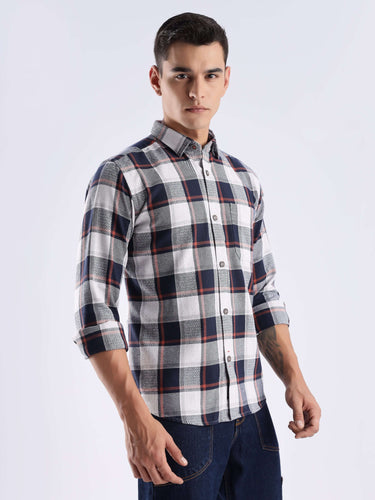 Man wearing a blue matrix checked shirt made from sustainable recycled cotton, showcasing style and durability.