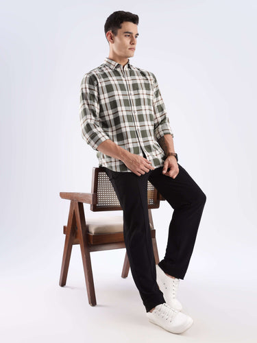 Man wearing a Meteor Green recycled cotton checked shirt, showcasing sustainable fashion and stylish comfort.