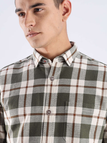 Close-up of a man wearing a Meteor Green recycled cotton checked shirt, showcasing its sustainable design and stylish pattern.