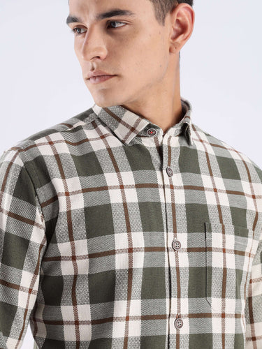 Man wearing a Meteor Green recycled cotton checked shirt with button details and stylish collar.